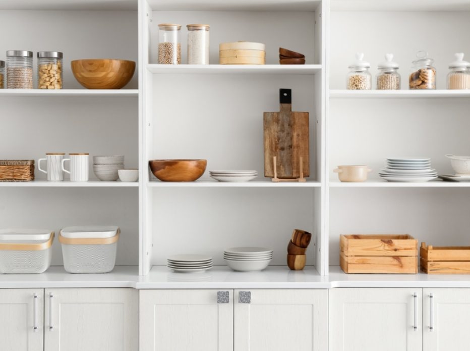 Shelf unit with clean dishware in kitchen